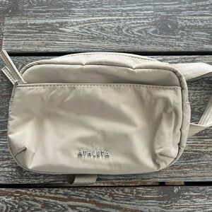 Athleta beige crossbody bag.